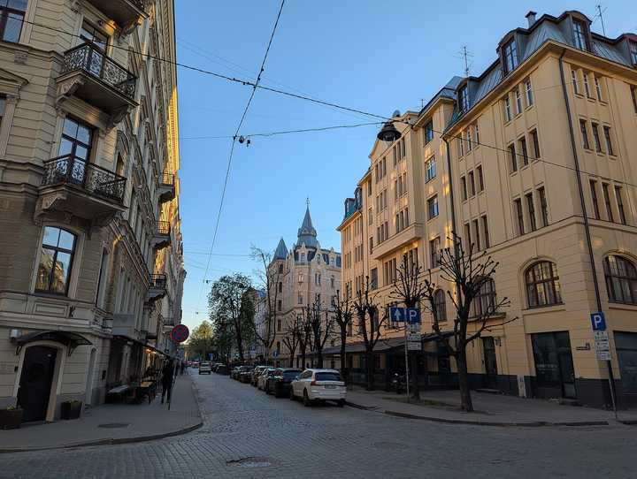 Antonijas iela in Rīga at dusk: cobbled street, Art Nouveau houses and a corner turret at the far end.